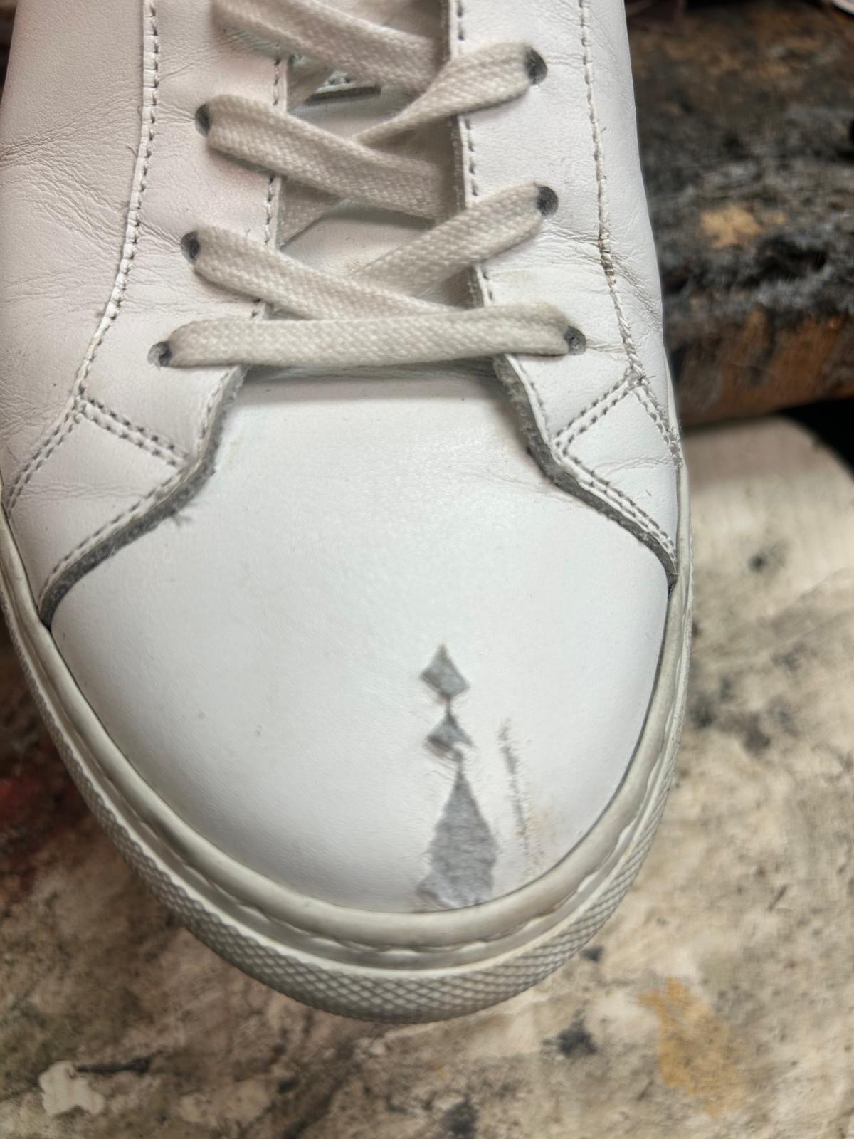 White sneaker with stain before