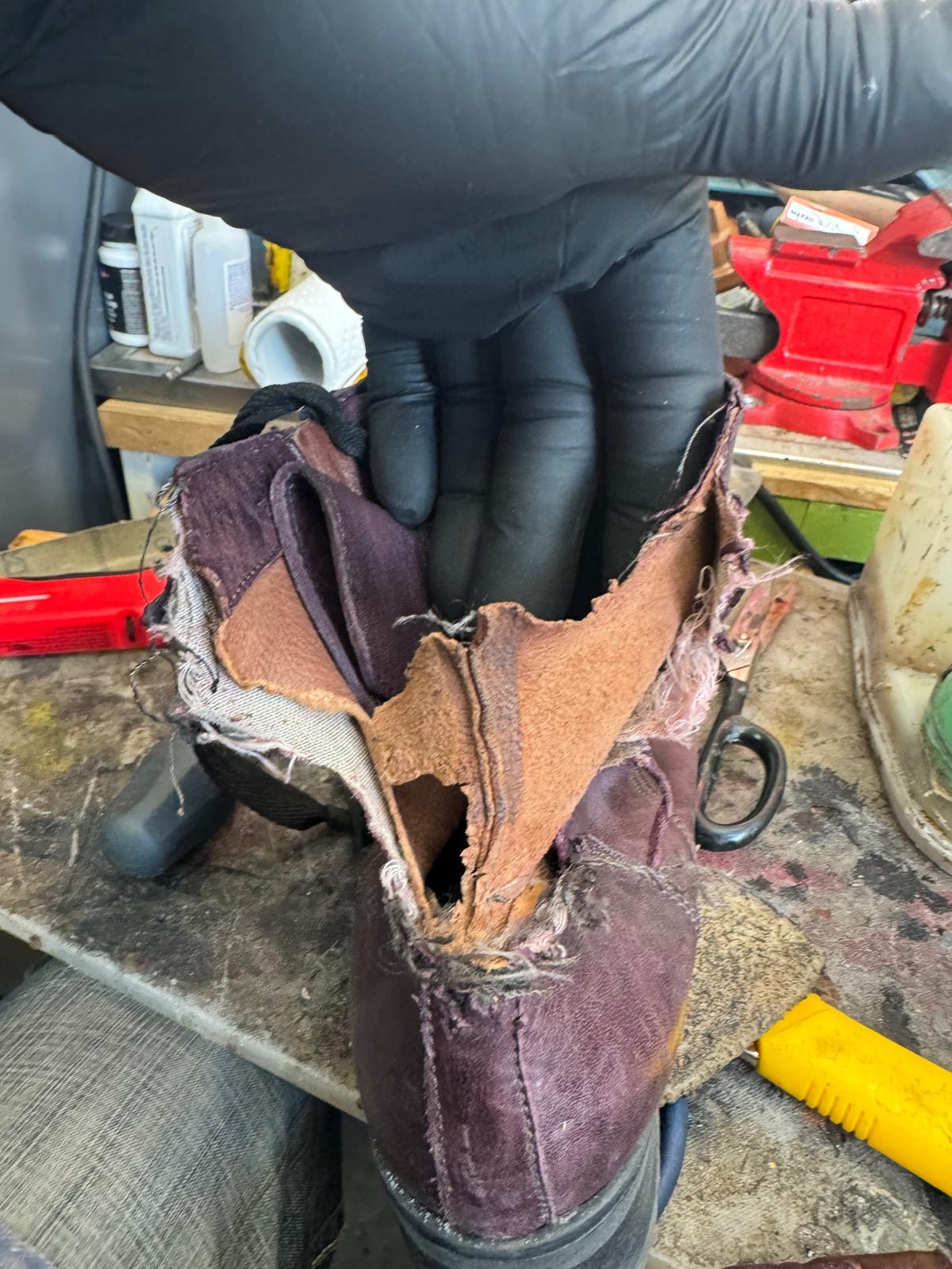 Damaged burgundy boots